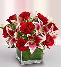 Hand-crafted arrangement of romantic roses and lilies in Glass Cube